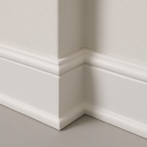 Primed white base moulding installed at corner wall junction