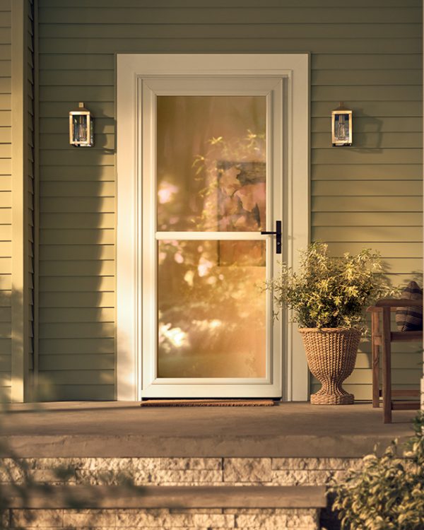 Larson fullview storm door installed on front entry with green siding and decorative lights