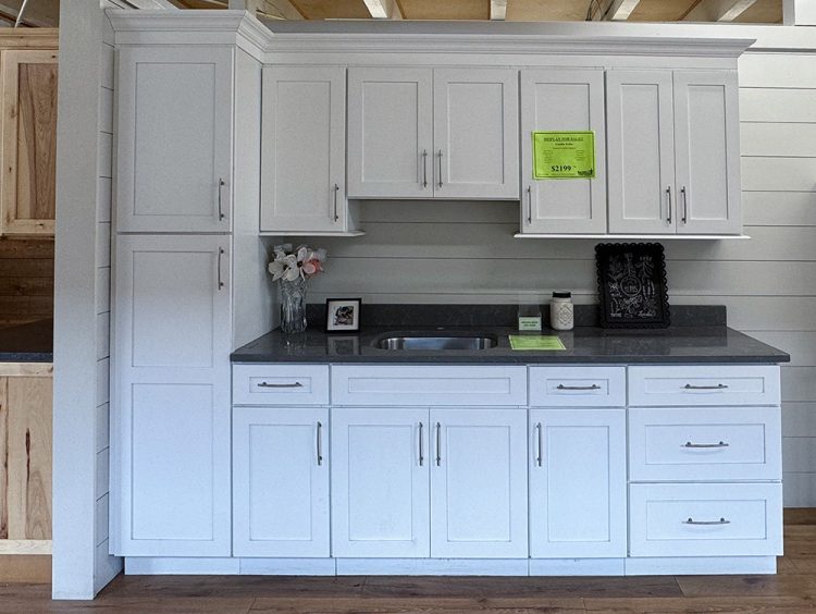 Arcadia White Shaker kitchen cabinet display with quartz countertop and stainless steel sink