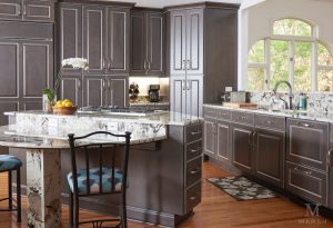 Kitchen with gray floor-to-ceiling cabinets, demonstrating kitchen cabinet replacement cost from Builders Surplus