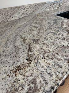Close-up texture detail of Nevasca Mist granite countertop