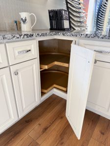 Lazy Susan corner cabinet in Newport White Kitchen Cabinet Display with Gran Perla Granite countertop