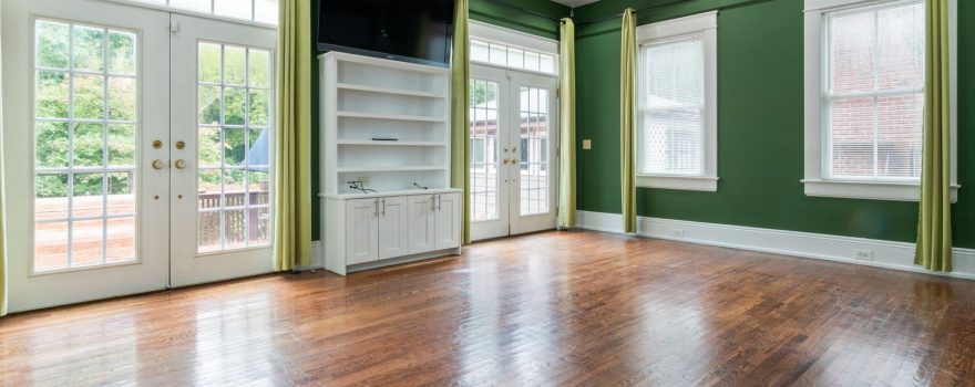 White French doors in a living room with hardwood floors.